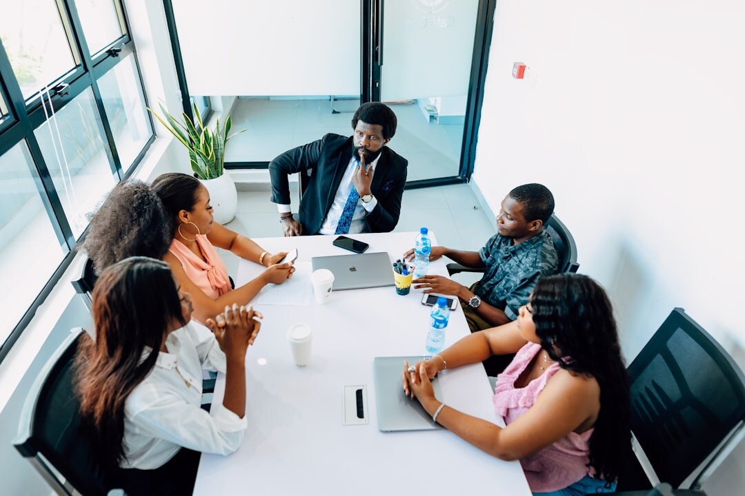 Diverse group of Belgian professionals discussing strategy in a boardroom